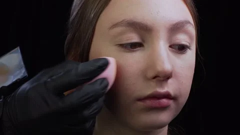 Applying foundation to face. Stock Footage 156807439