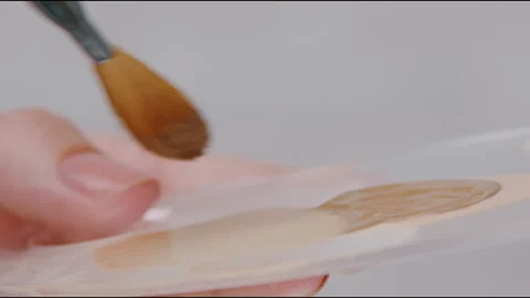 Applying Foundation Using a Brush for Created Flawless and Radiant Skin Stock Footage 327622831