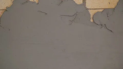 Applying fresh grey plaster on aerated concrete block wall during home Stock Footage 345538130