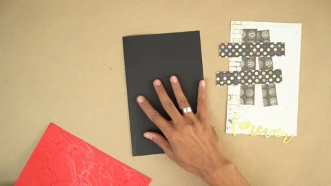 Applying glue to red piece of paper during arts and crafts card-making Stock Footage 289367644