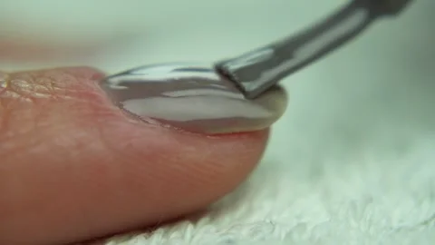 Applying gray nail polish. Close up finger during manicure process. Macro shot Stock Footage 241147077
