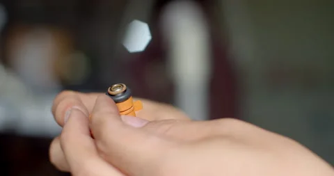 Applying grease to the fuel injector O-ring to ensure smooth insertion. Stock Footage 314767818