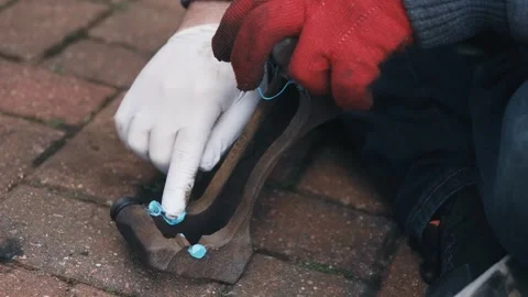 Applying high performance anti squeal lubricant to caliper contact points during Stock Footage 335369032