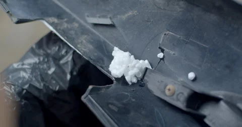 Applying hot glue to melted foam to create a stronger bond for repairing. Stock Footage 321798643