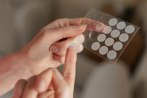 Applying Hydrocolloid Acne Patch From Sheet Skincare Treatment Closeup Stock Photos