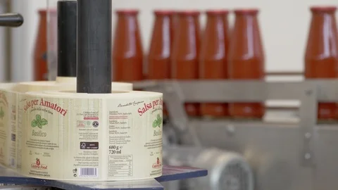 Applying label on Tomato Sauce Bottles- Tomato sauce Factory Stock Footage 96328287