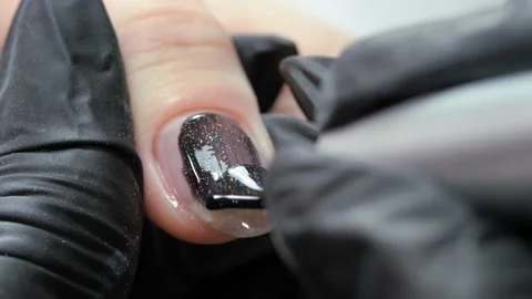 Applying a layer of black varnish to the nail surface. Stock Footage 174891377