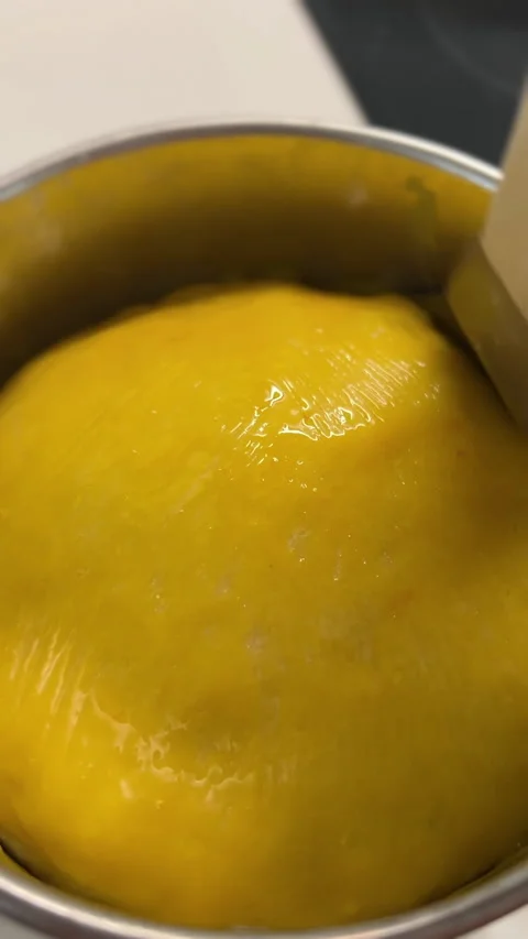 Applying a layer of Brushing Glaze on a Yellow Batter while working in the Stock-Footage 306079350