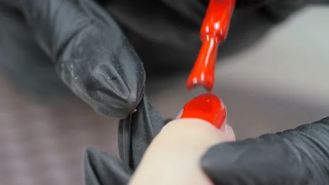 Applying a layer of red varnish to the nail surface. Stock Footage 196121417