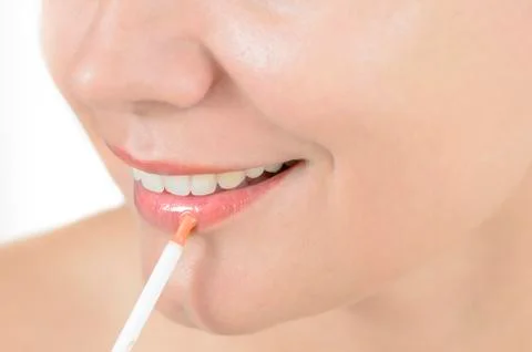 Applying lip gloss Stock Photos