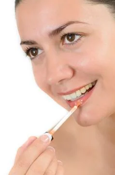Applying lip gloss Stock Photos