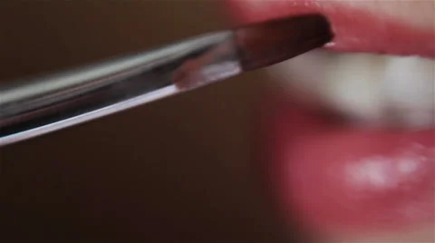 Applying lipstick with a brush. Close-up. Stock Footage 46304354