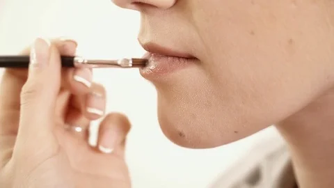 Applying lipstick to the woman's lips closeup Video stock 75382934