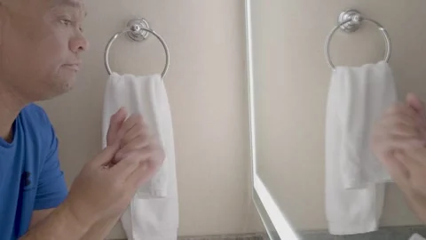 Applying lotion in the hotel bathroom Stock Footage 320974960