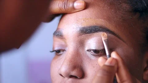 Applying make up on eye shadow with a makeup brush.	 Stock Footage 217875072