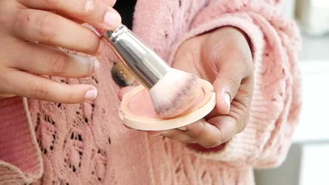 Applying makeup with brush in bright setting Stock Footage 343805549