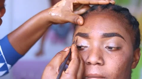 Applying makeup foundation on eye shadows Stock Footage 204948406