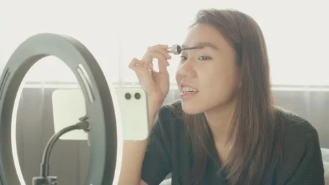 Applying Makeup in Front of a Mirror Stock Footage 319415066