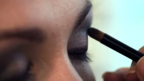 Applying makeup. guidance of beauty. application of eye shadow Video stock 82498073