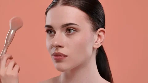 Applying Makeup with Precision Using Brush and Powder Stock Footage 313594270