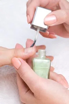 Applying manicure, moisturizing the nails Stock Photos