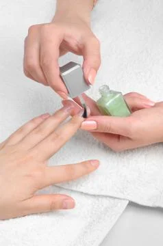 Applying manicure, moisturizing the nails Stock Photos