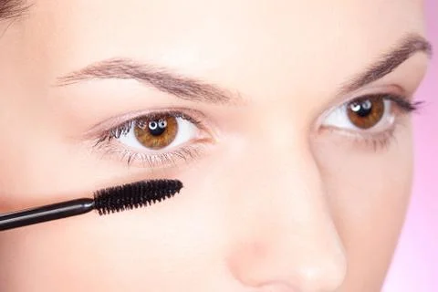 Applying mascara on eye Stock Photos