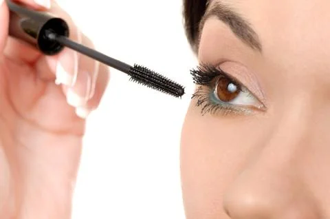 Applying mascara using lash brush Stock Photos
