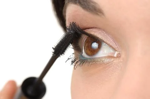 Applying mascara using lash brush Stock Photos