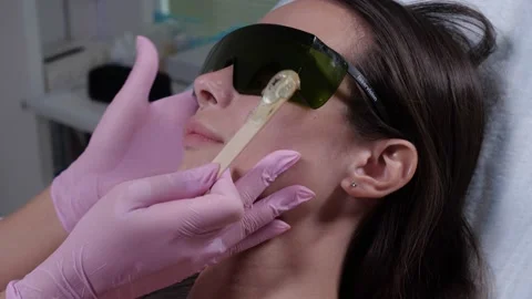 Applying the master contact gel for laser hair removal in a beauty salon Stock Footage 134861057