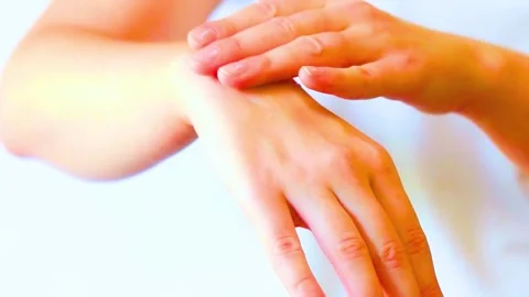 Applying moisturizing hand cream on dry skin against white background Stock-Footage 342905316