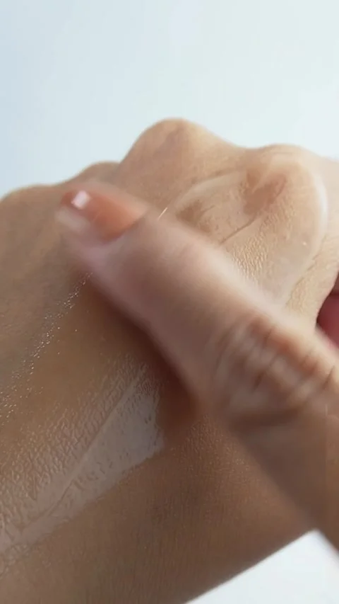 Applying moisturizing skin cream onto back of hand with finger. Close up of.. Stock Footage 336238668