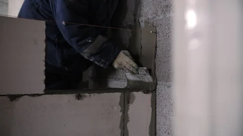 Applying Mortar to Block Wall During Construction Stock Footage 327812083