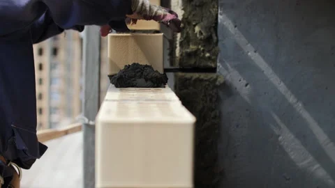 Applying Mortar to Ceramic Block Wall Stock Footage 313757974