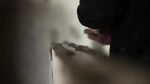 Applying mortar to a construction wall Stock Footage 327747817