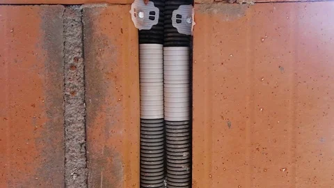 Applying mortar on a wall to fill gaps with empty conduits Stock Footage 119286516