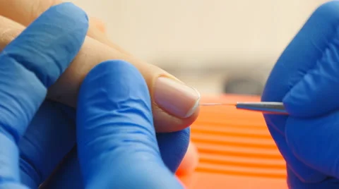 Applying nail polish on nails with a brush for applying nail polish on fingers Stock Footage 64619797