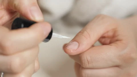Applying nail polish to the thumb nail. Close-up of a nail brush. Manicure. Stock Footage 267209212
