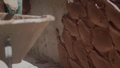 Applying natural bio plaster on an environmentally friendly building wall Stock Footage 342256997