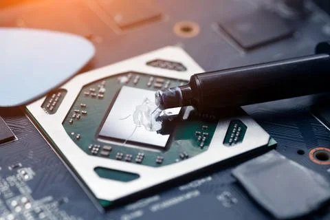 Applying new thermal paste to the processor. The master serves the computer Stock Photos