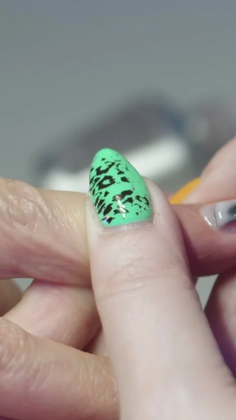 Applying the nude base on the nail of the finger Stock Footage 328371150
