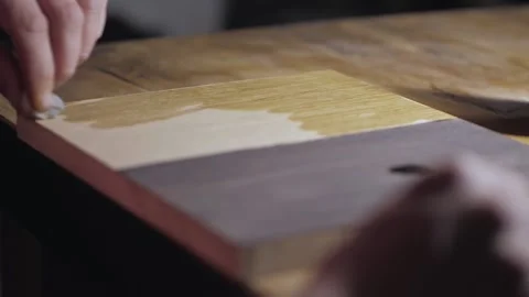 Applying oil on a wooden oak board with a sponge. woodworking concept Stock Footage 156670341