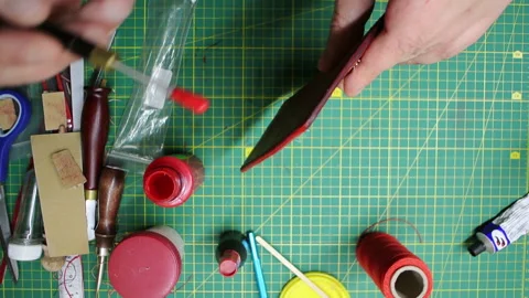 Applying paint to the edges red leather wallet DIY craft 스톡 동영상 148049516