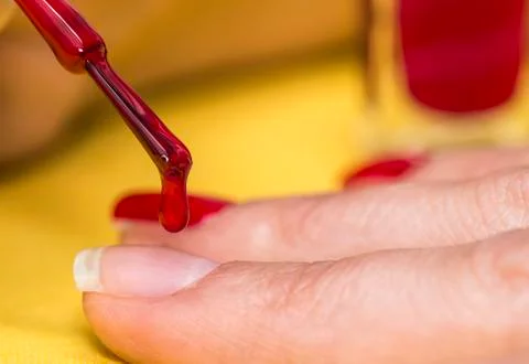 Applying paint to a nail Stock Photos