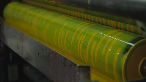 Applying paint to paper cups using a specialized machine. 動画素材 156718960