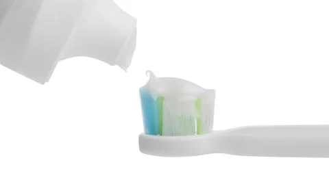 Applying paste on electric toothbrush against white background, closeup 스톡 사진