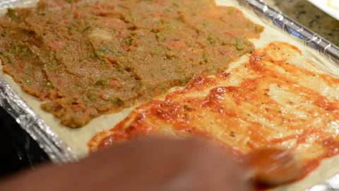 Applying Pizza Sauce to Half of Pizza Stock Footage 130356349
