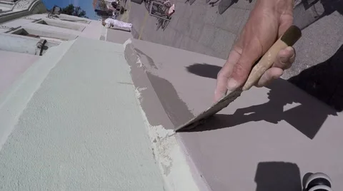 Applying plaster on the wall with trowel in hand Stock Footage 62707792
