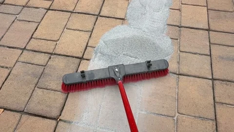 Applying Polymeric Sand Between Patio Pavers Stock Footage 337887404