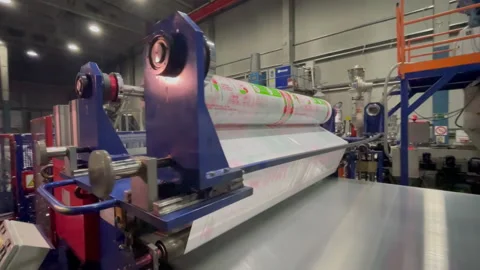 Applying protective film with information on plastic sheets Stock Footage 231721094